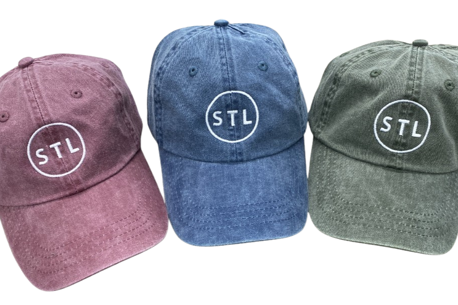 Three baseball caps in different colors with 'STL' logo on a white background