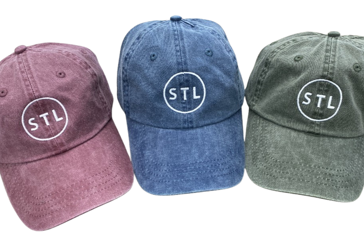 Three baseball caps in different colors with 'STL' logo on a white background